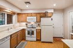 The newly upgraded kitchen with new Corian countertops and new appliances is fully-equipped